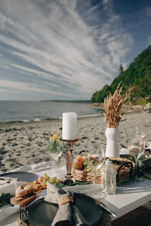 Perfect Beach Picnic Setup On A Sunny Day- Wallpaper