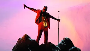 Performer_on_ Mountain_ Peak_at_ Dusk Wallpaper