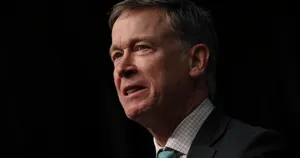 Permanent Governor John Hickenlooper Poses Against A Black Backdrop Wallpaper