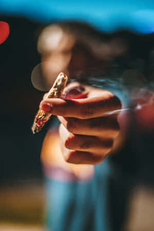 Person Holding A Joint Wallpaper