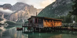 Person Walking A Lake Side Trail Wallpaper