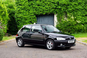 Peugeot106 Black Hatchback Parked Wallpaper