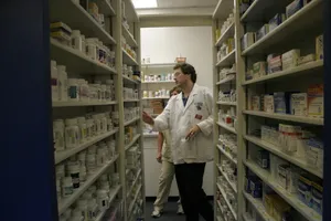 Pharmacist Looking Over Medicines Wallpaper