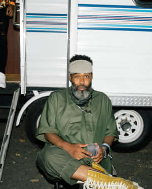 Pharoahe Monch Seated Outdoors Wallpaper