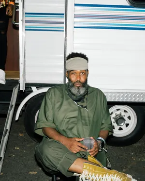 Pharoahe Monch Seated Outdoors Wallpaper