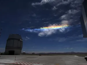 Phenomenal Rainbow Among The Clouds Wallpaper