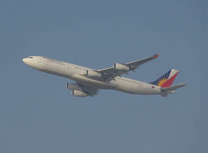 Philippine Airlines Airplane In Gloomy Skies Wallpaper