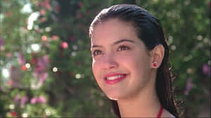 Phoebe Cates Smiling In A Classic Red Dress Wallpaper