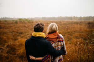 Photo Of A Couple Holding Each Other Representing A Tangible Love Wallpaper