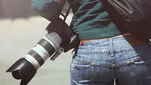 Photographer Carrying A Camera Wallpaper
