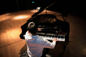 Pianist Performingon Stageat Concert Wallpaper