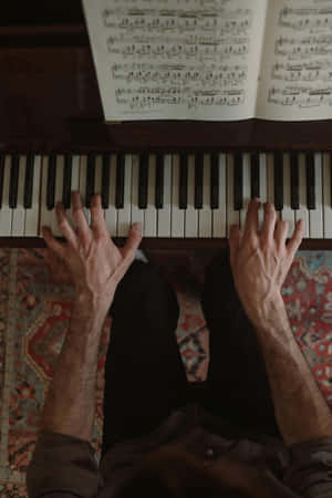 Pianist Practicing With Sheet Music Wallpaper