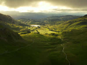 Picturesque Landscape Of The Rolling Hills Of A Pristine Valley Wallpaper