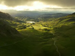 Picturesque Landscape Of The Rolling Hills Of A Pristine Valley Wallpaper