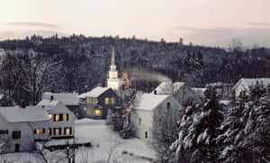 Picturesque Snowy Village In Winter Wallpaper