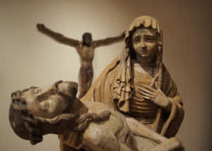 Pieta_ Sculpture_with_ Crucifix_ Background Wallpaper