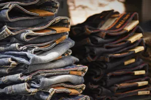 Pile Of Denim Jeans In Different Colors Wallpaper