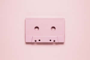 Pink Cassette Tapeon Pastel Background Wallpaper