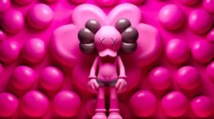Pink Kaws Figure Against Bubble Backdrop Wallpaper