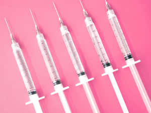 Pink Medical Syringes Aesthetic Wallpaper
