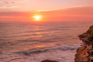 Pink Orange Sunset Over Sea Cliffs Wallpaper