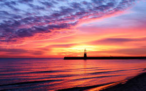 Pink Sunset Distant Lighthouse Wallpaper