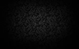 Plain Black Desktop With Swirling Leaves Wallpaper