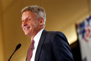 Politician Gary Johnson Smiling With Yellow Back Drop Wallpaper