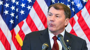 Politician Speaking American Flags Background Wallpaper