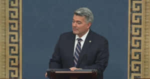 Politician Speakingat Podium Wallpaper