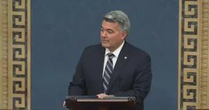 Politician Speakingat Podium Wallpaper