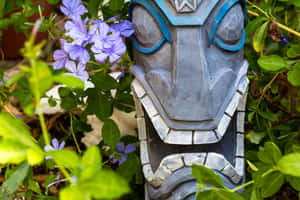 Polynesian Tiki Statue Among Flowers Wallpaper