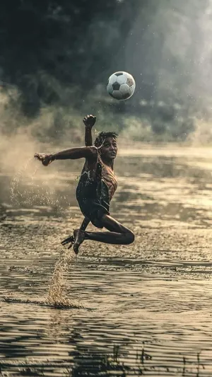 Poor Kid Playing Soccer Wallpaper
