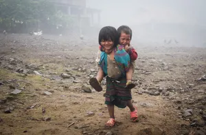 Poor Little Girl Carrying Her Brother Wallpaper