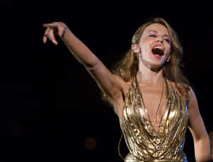 Pop Icon Kylie Minogue Performing On Stage Wallpaper