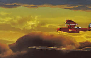 Porco Rosso Soaring Through The Skies In His Red Seaplane Wallpaper