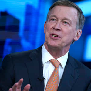 Portrait Of John Hickenlooper With A Blue Backdrop Wallpaper
