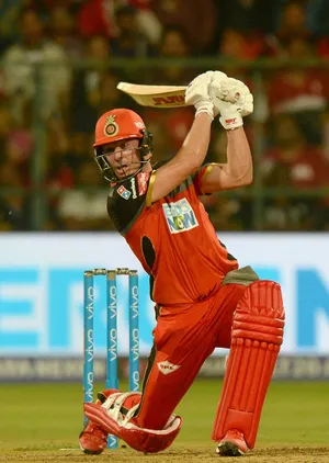 Power Stance - The On-field Strength Of Ab De Villiers In Rcb Gear Wallpaper