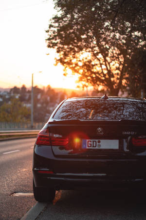 Powerful Elegance: Experience The Charm Of Classic Black Bmw M Series Car Wallpaper