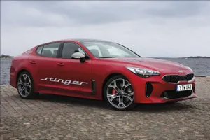 Powerful Kia Stinger Sports Car In Action Wallpaper