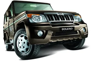 Powerful Mahindra Suv Driving Through Rough Terrain Wallpaper