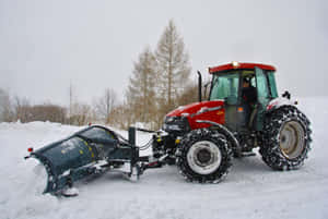 Powerful Snowplow Clearing The Road Wallpaper