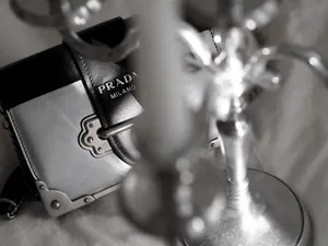 Prada Sling Bag On Table Wallpaper