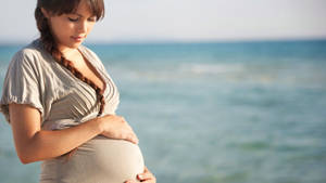 Pregnant At Beach Shore Wallpaper