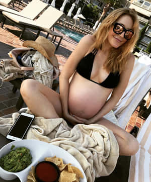 Pregnant Woman Relaxing Poolside Wallpaper