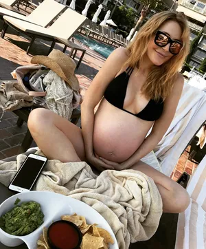 Pregnant Woman Relaxing Poolside Wallpaper