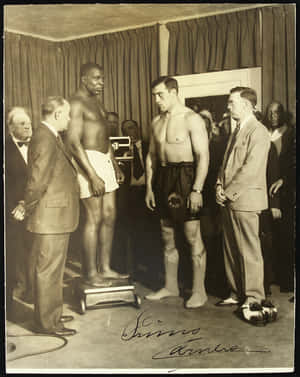 Primo Carnera During A Pre-fight Weigh-in Wallpaper