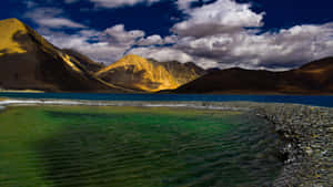 Pristine_ Kashmir_ Lake_ Surrounded_by_ Mountains Wallpaper