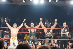 Pro Wrestlers Celebrating Victoryin Ring Wallpaper