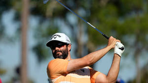 Professional Golfer Adam Hadwin In Full Swing Wallpaper